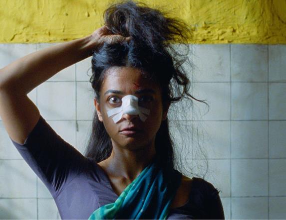 woman staring ahead with bandage on her nose