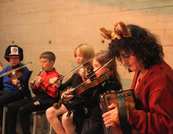 Acadamh students playing instruments.