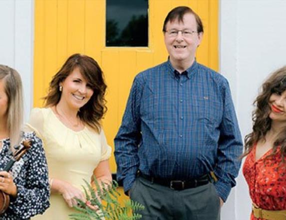 Photo of the Murphy family in front of a yellow door