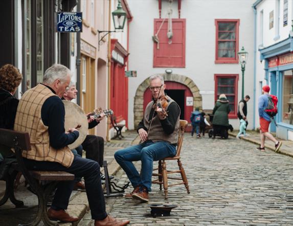 A group of musicians playing at the Folk Park
