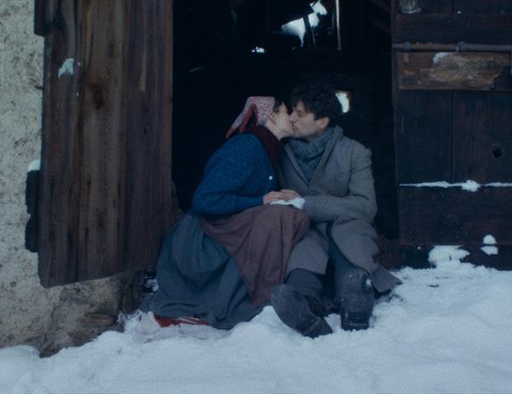 Man and women sitting in snow