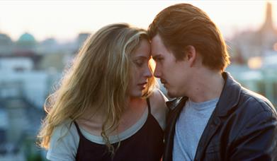 man and woman closely looking at one another