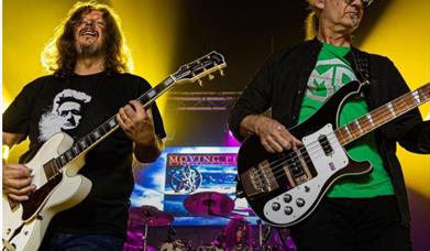 Moving pictures frontmen playing guitars on stage