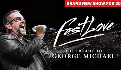 George Michael Tribute standing in front of a large, darkly lit stadium, wearing a leather jacket and sunglasses, singing passionately. The words 'Fas