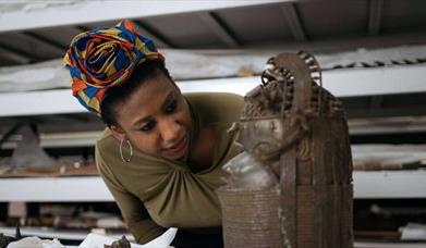 woman looking at bronze sculpture