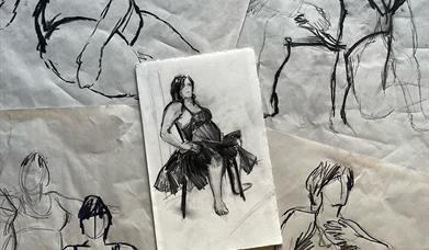 Several sketches in charcoal of a woman