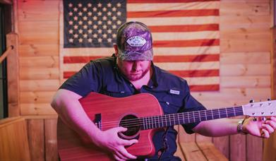 Image of Luke Combs playing guitar