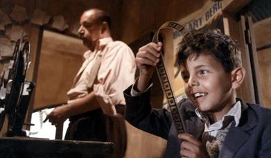 man and young boy in cinema projection room