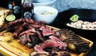 Barbecued meat on a chopping board