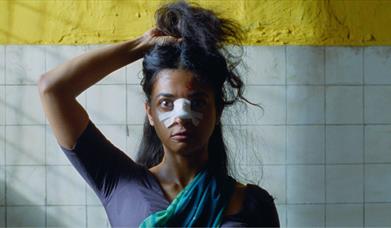 woman staring ahead with bandage on her nose