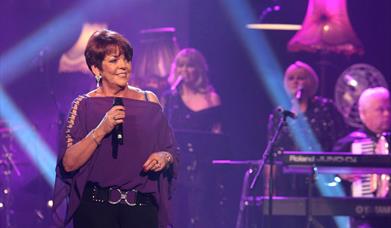 Image shows Susan performing on stage