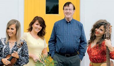Photo of the Murphy family in front of a yellow door