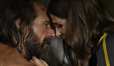 man and woman closely looking at one another