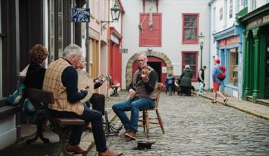 A group of musicians playing at the Folk Park