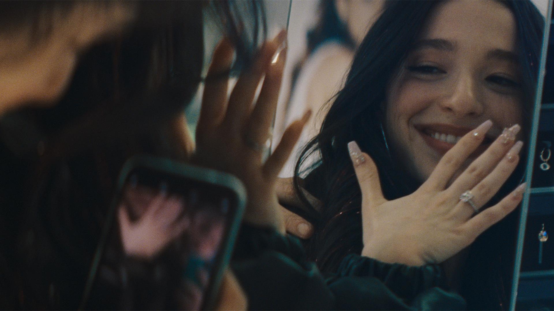 Women looking in mirror wearing ring