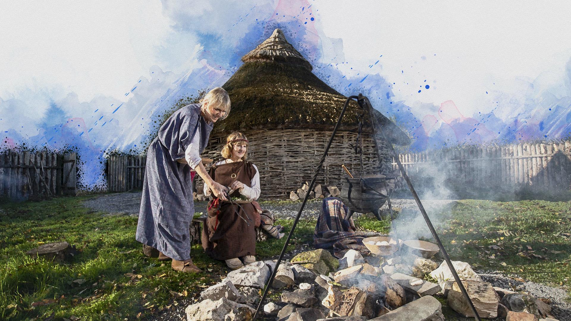 Mother and child smiling beside fire pit