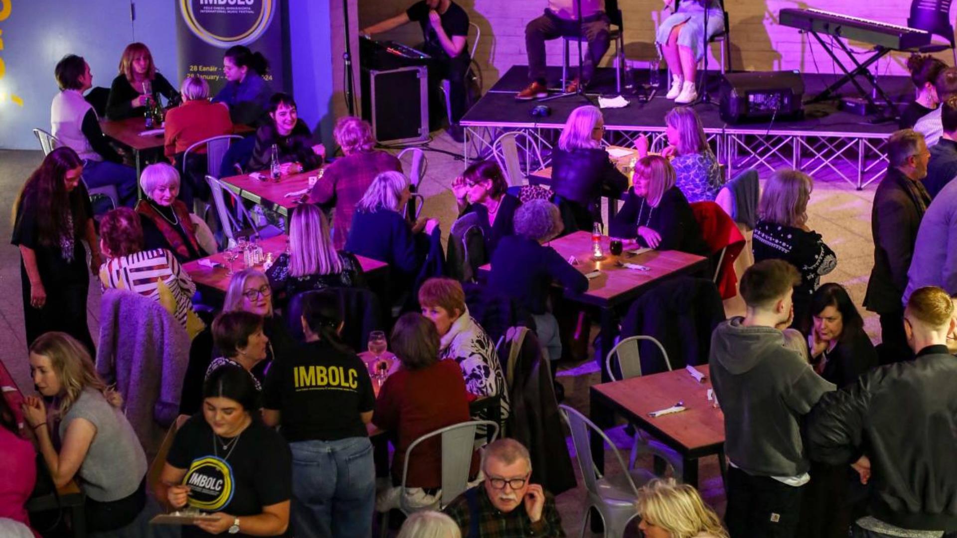 image of traditional music being played to a large group in the Cultúrlann