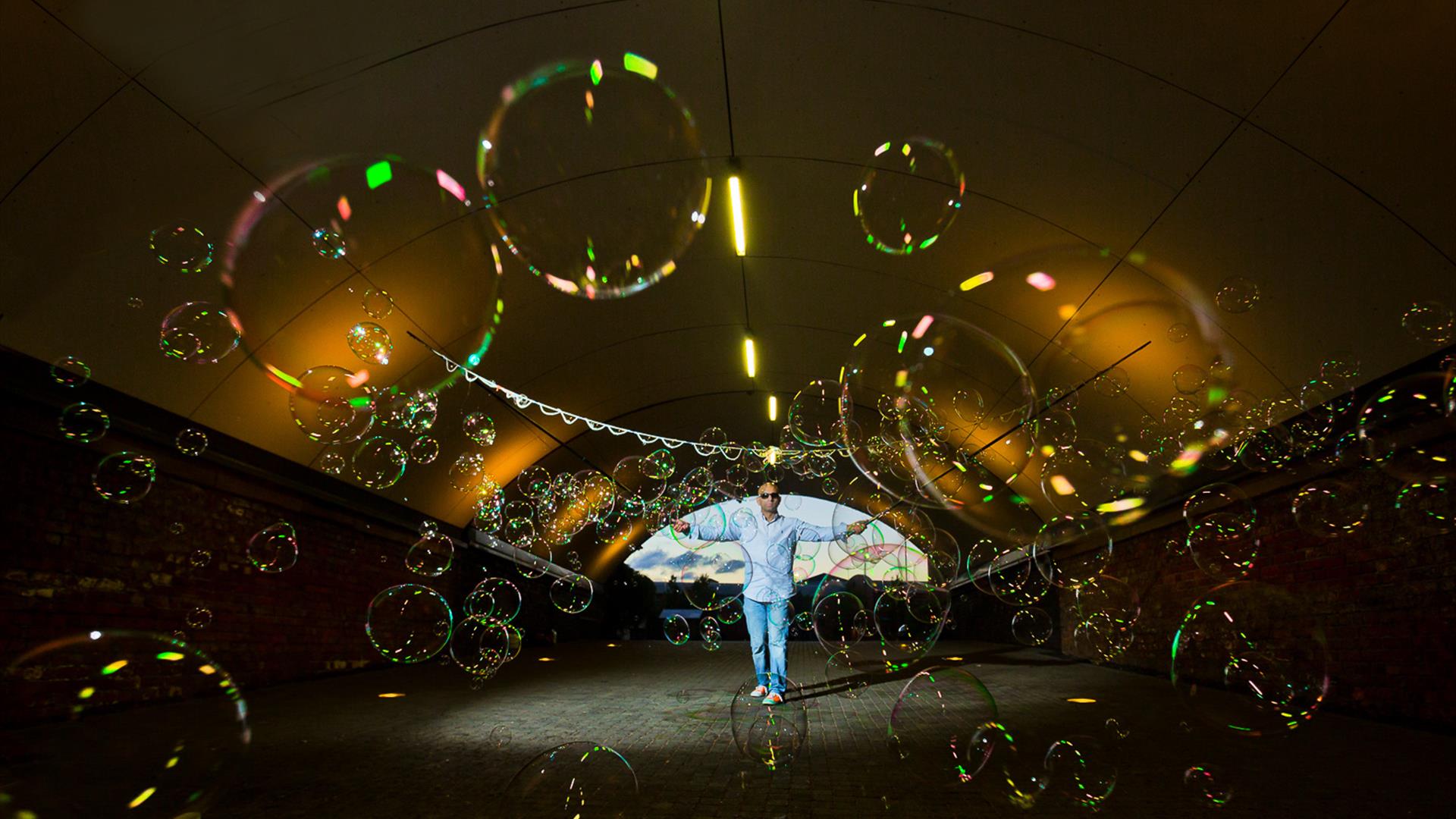 Image of a man in a stretch tent filled with bubbles