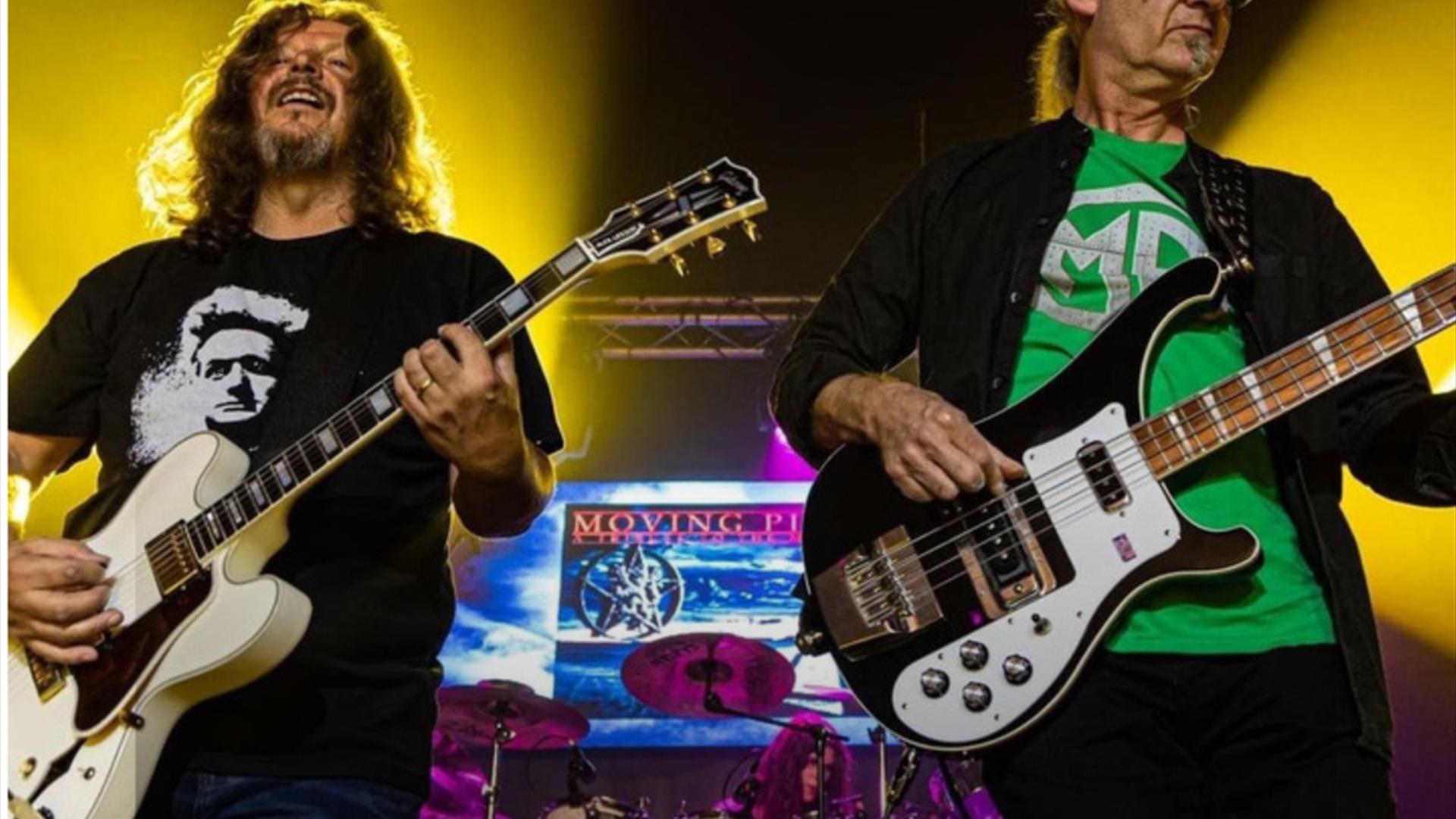 Moving pictures frontmen playing guitars on stage
