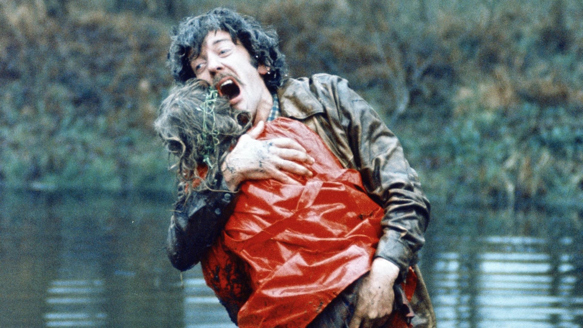 A male character holding someone in his arms.