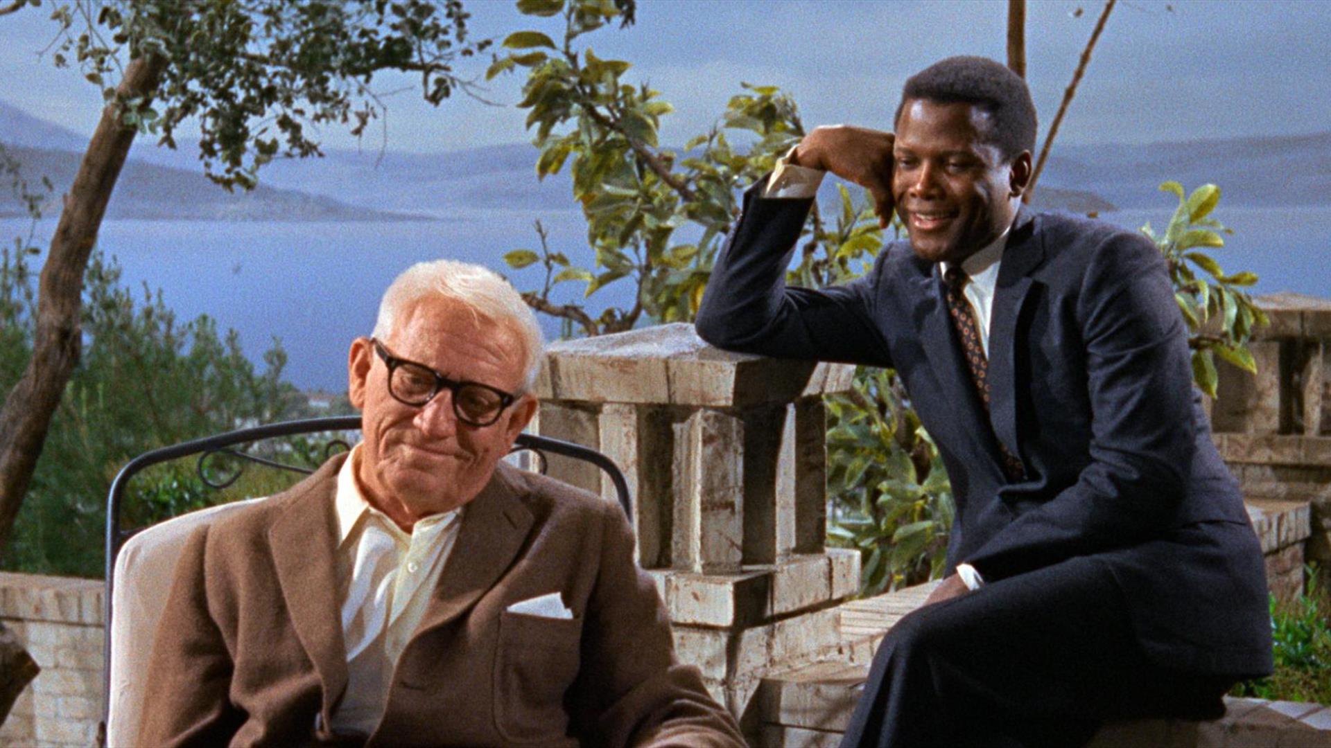Two men outside smiling