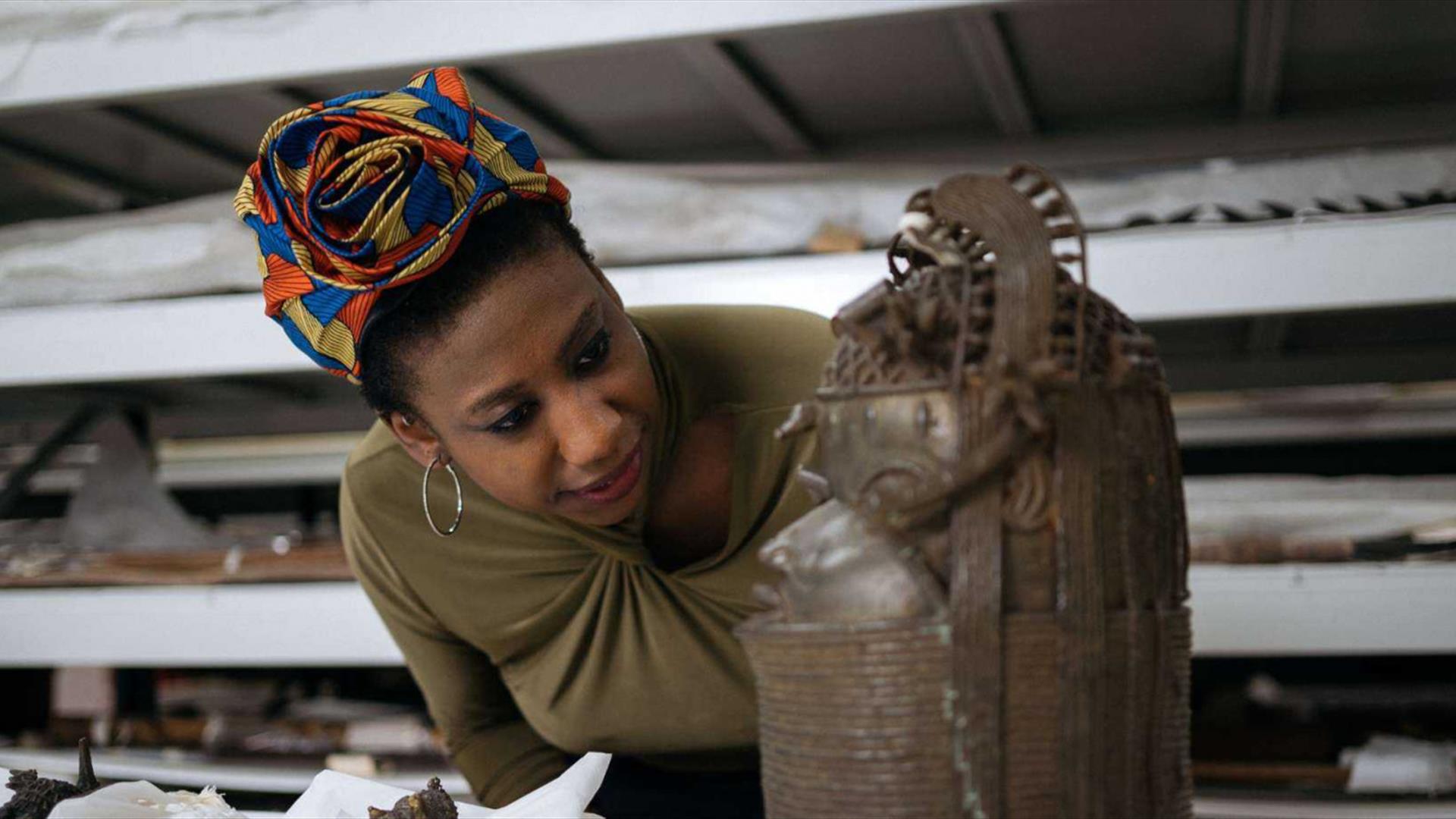woman looking at bronze sculpture