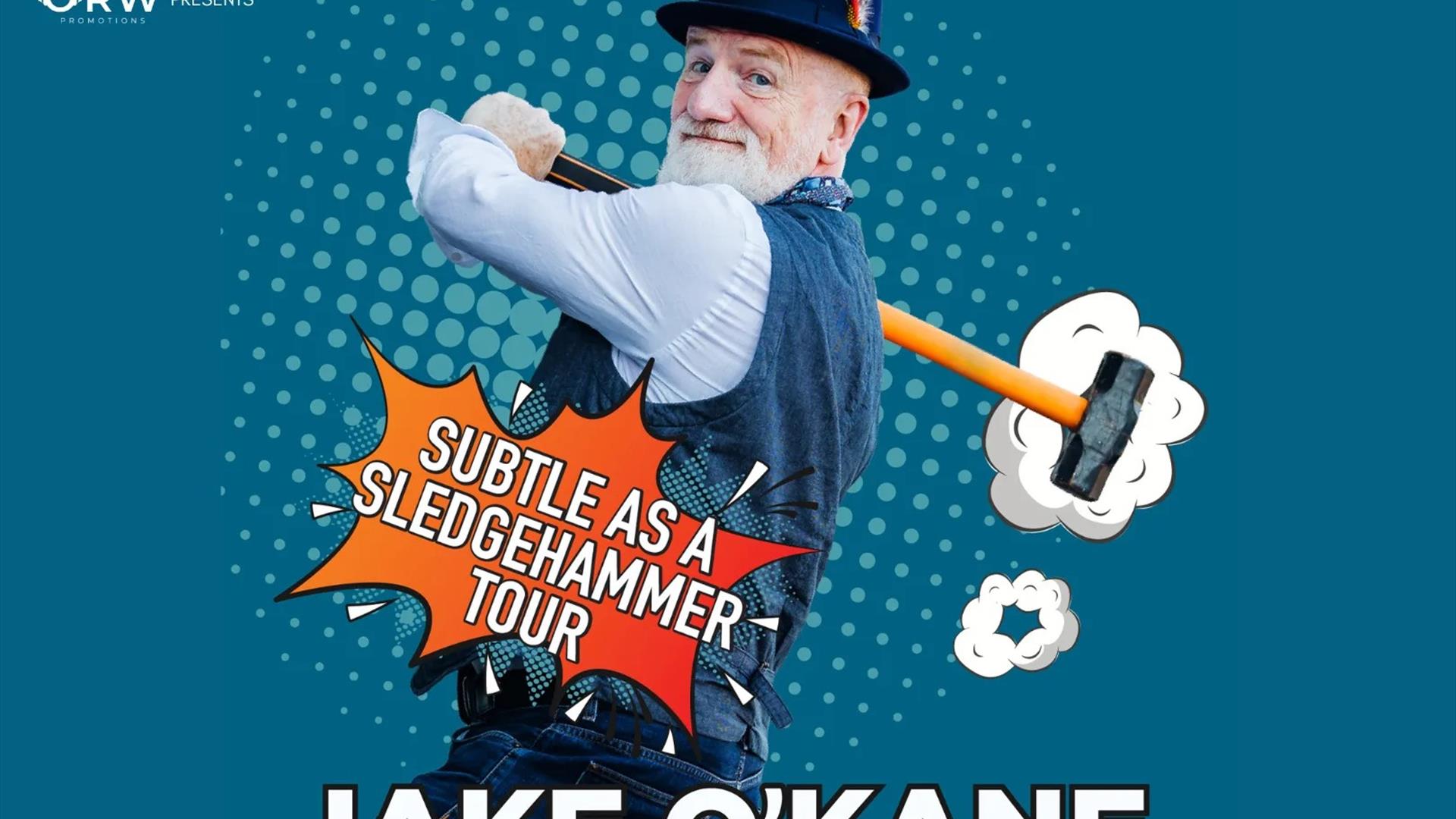 Promotional artwork for comedian Jake O'Kane's Subtle as a Sledgehammer Tour. Jake O'Kane is pictured wearing a hat, waistcoat and shirt, smiling over