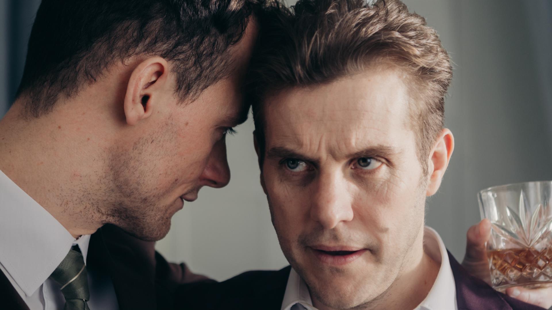 Two men in intimate conversation