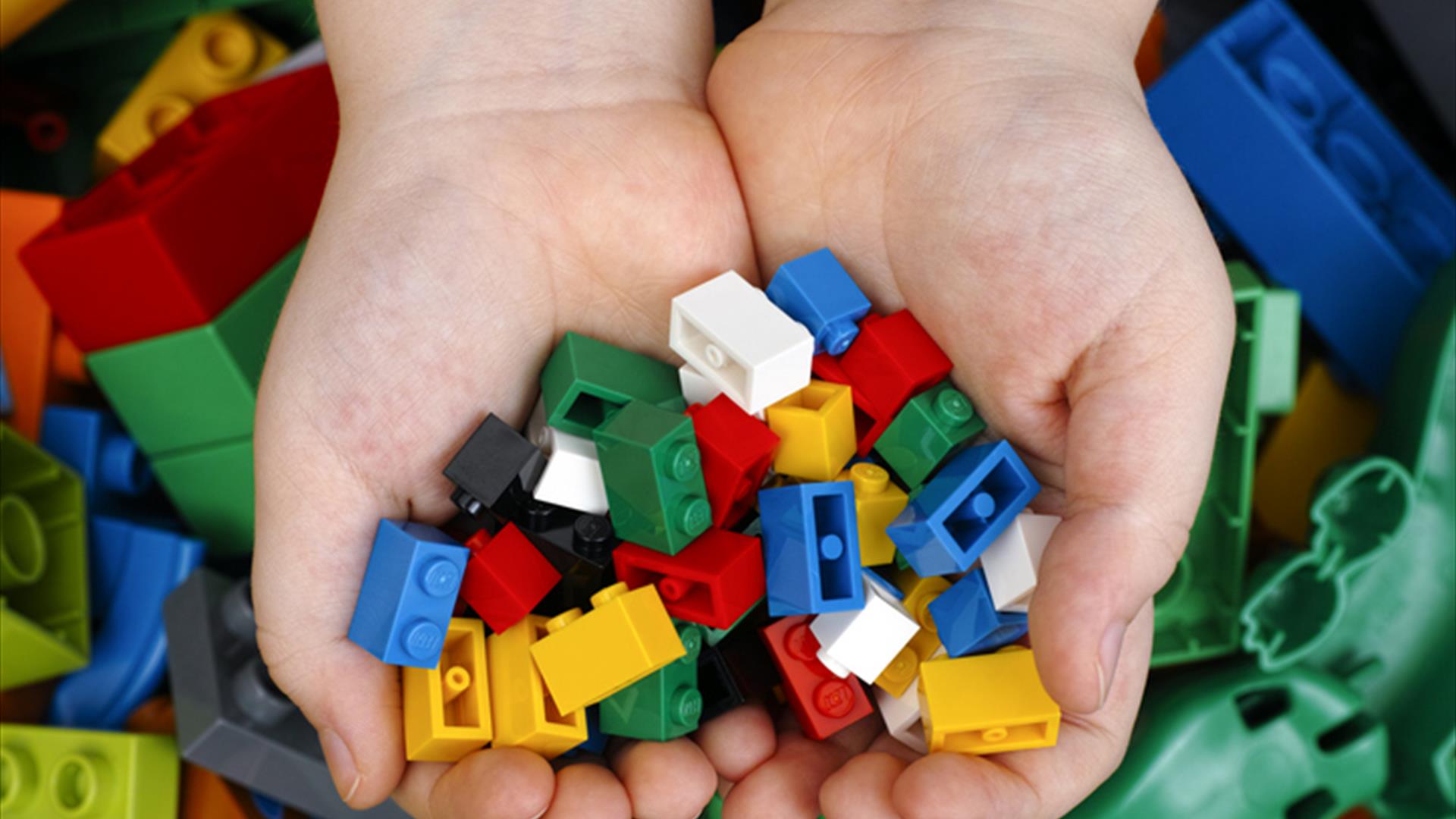 Lego bricks in a childs hands.