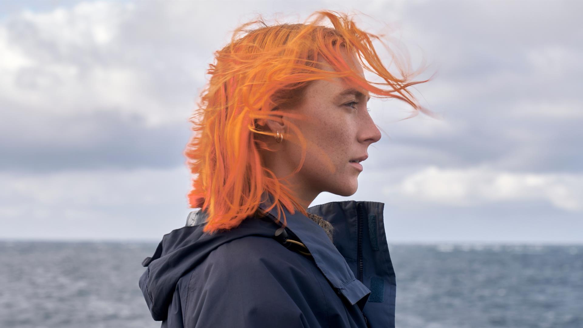 Woman with orange hair at the beach