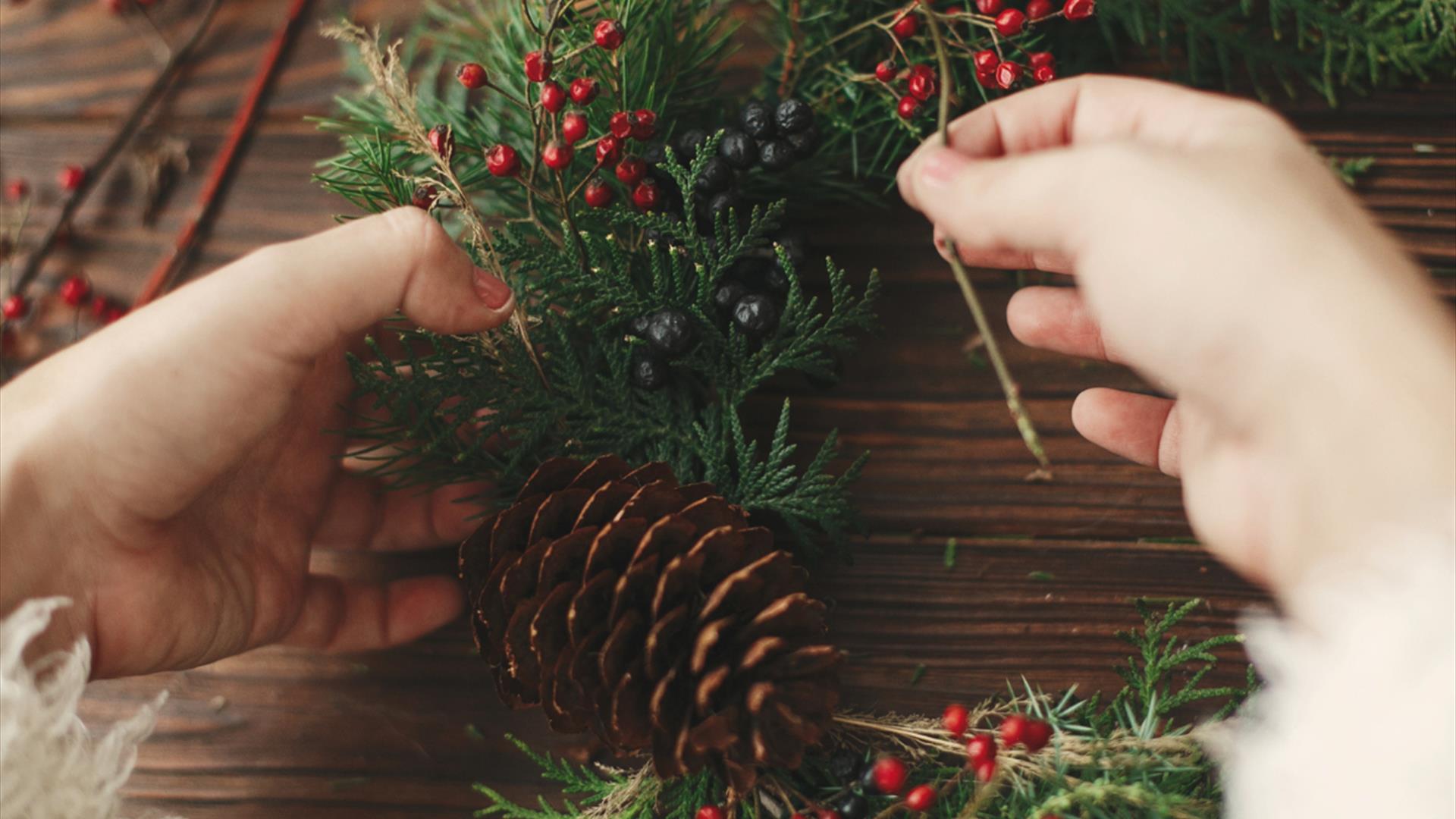hands crafting a pine wreath