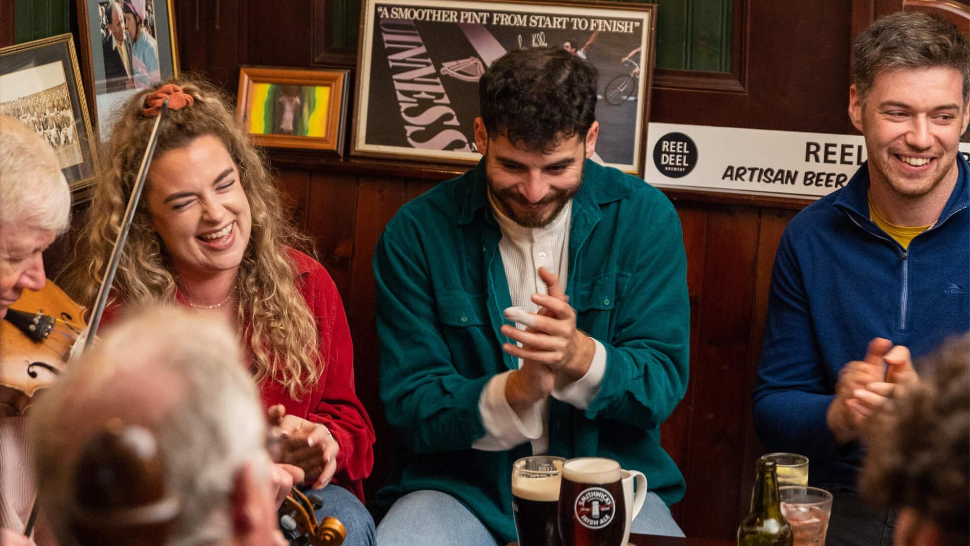 Group of people enjoying Irish music in a pub