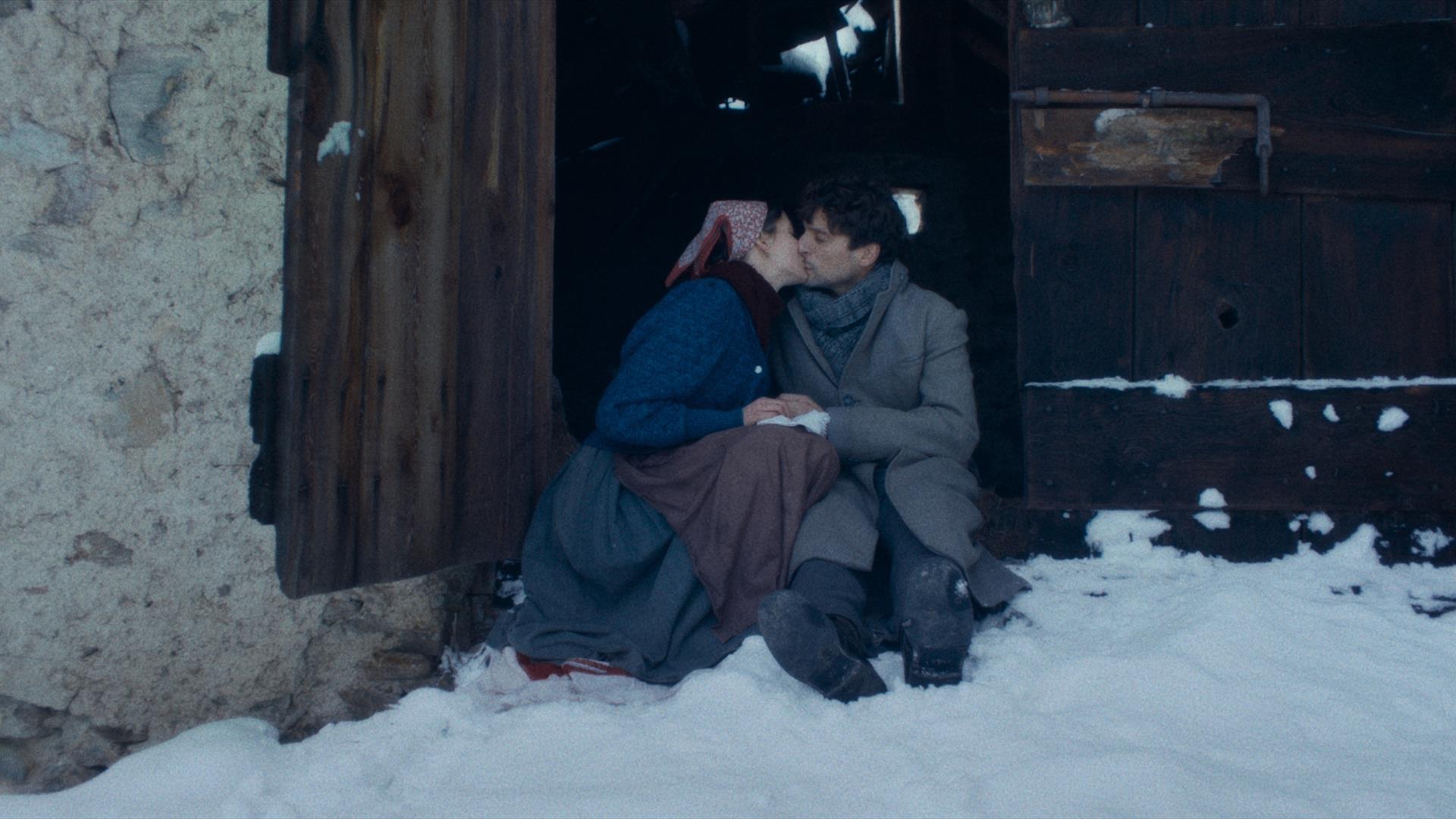 Man and women sitting in snow