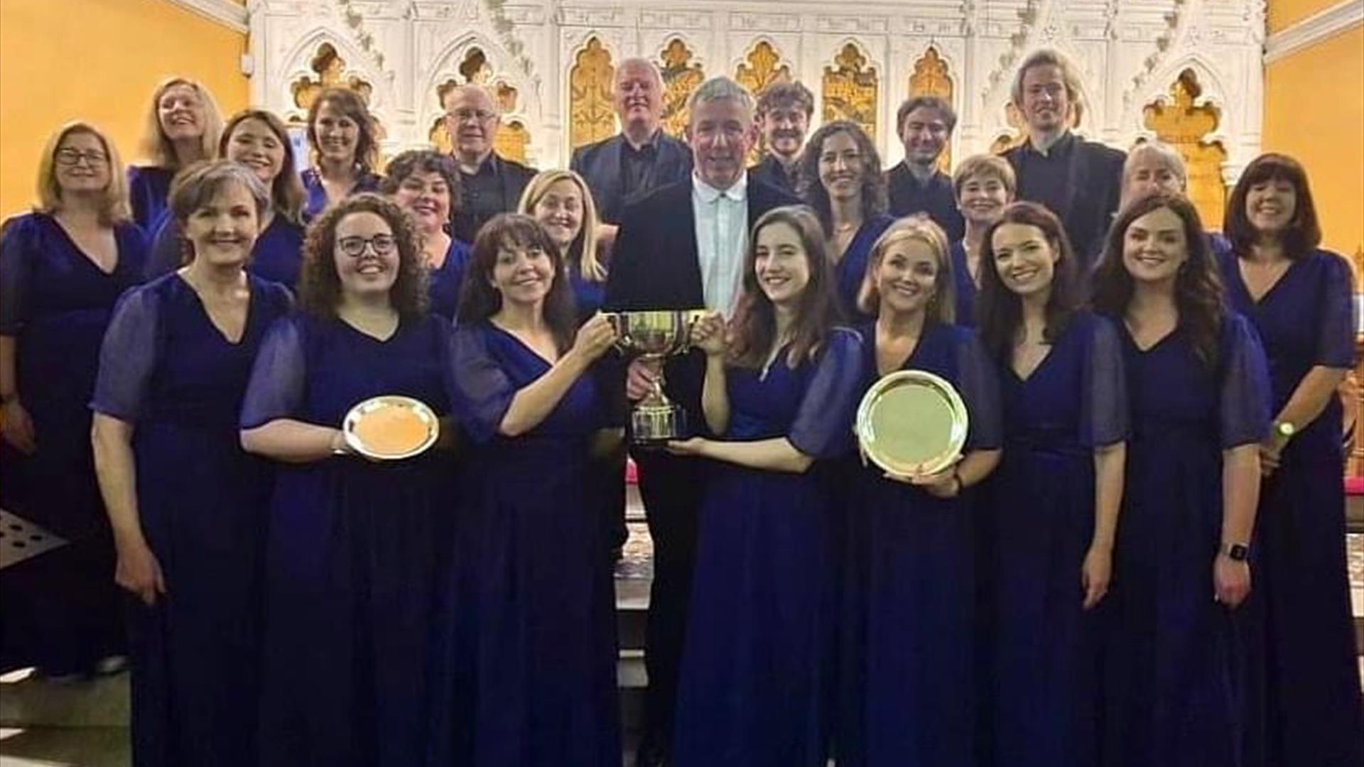 Image shows choir posing with awards in a group