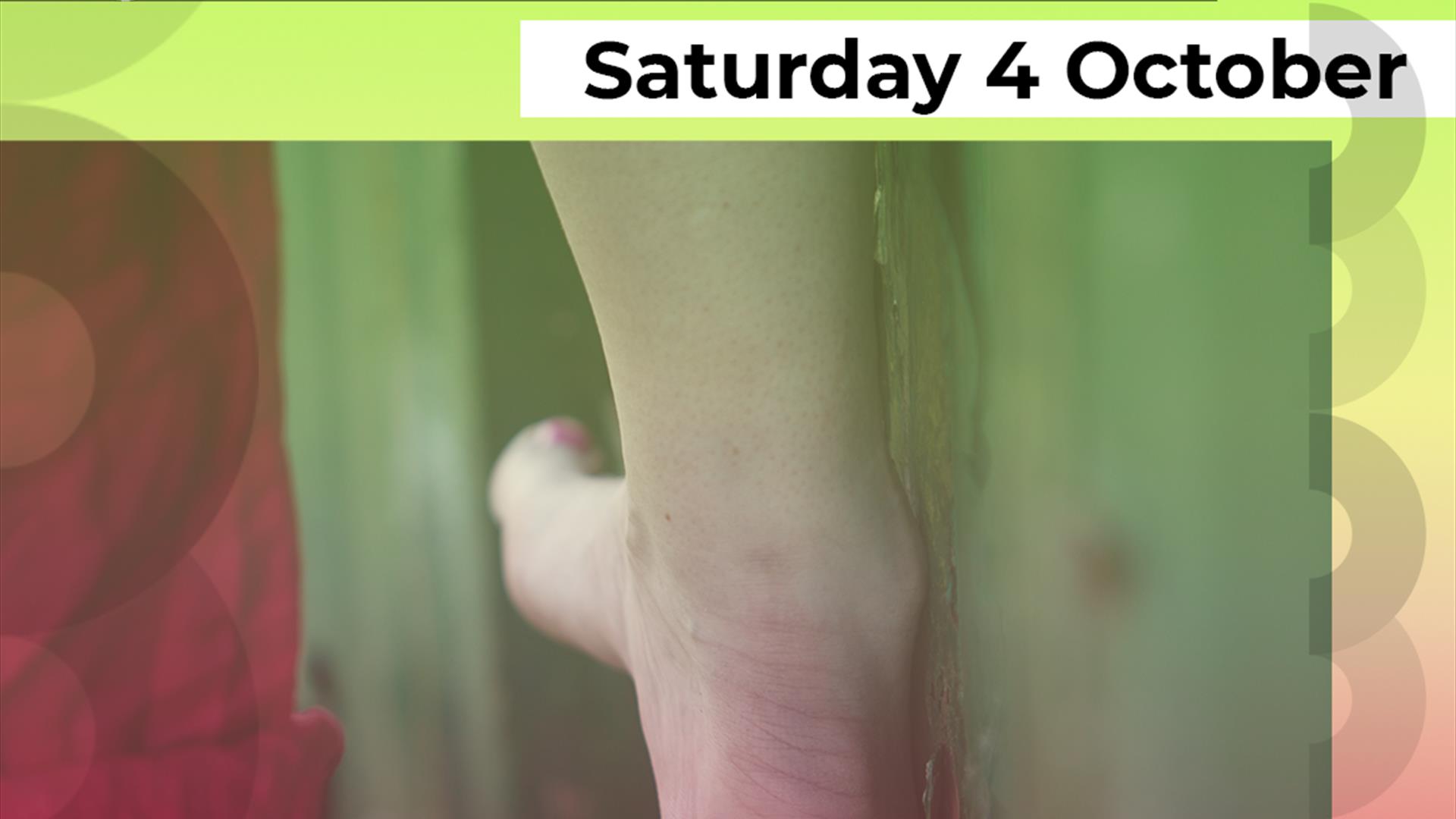 A photograph of a woman's right foot balancing on a slim piece of wood. The foot is facing away and the big toe is painted pink. Above the photograph