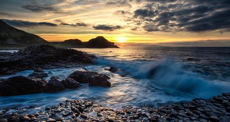 waves lap over the basalt stones at the giants causeway