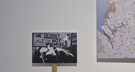 Placards against a white wall