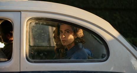 woman looking out of car window