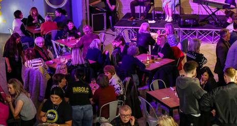 image of traditional music being played to a large group in the Cultúrlann