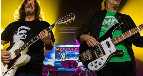 Moving pictures frontmen playing guitars on stage
