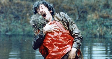A male character holding someone in his arms.