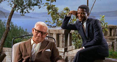 Two men outside smiling