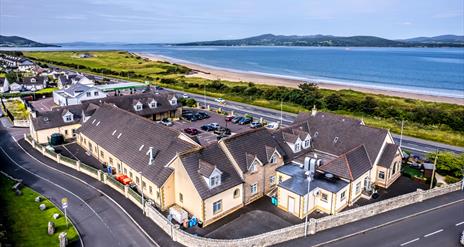 Aerial image of Harbour Inn with Lough Swilly in the background