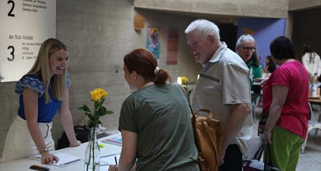 Person welcoming another person in An Chultúrlann