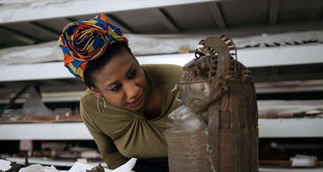 woman looking at bronze sculpture