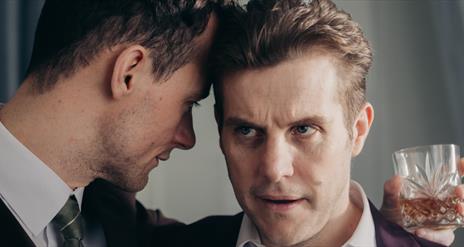 Two men in intimate conversation