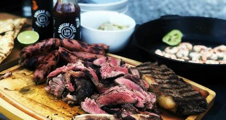 Barbecued meat on a chopping board