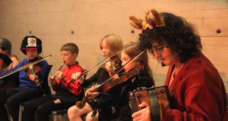 Acadamh students playing instruments.