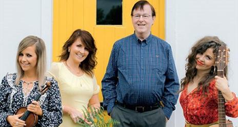 Photo of the Murphy family in front of a yellow door