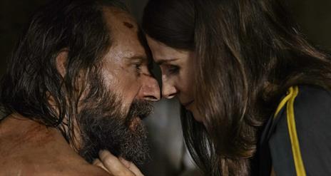 man and woman closely looking at one another